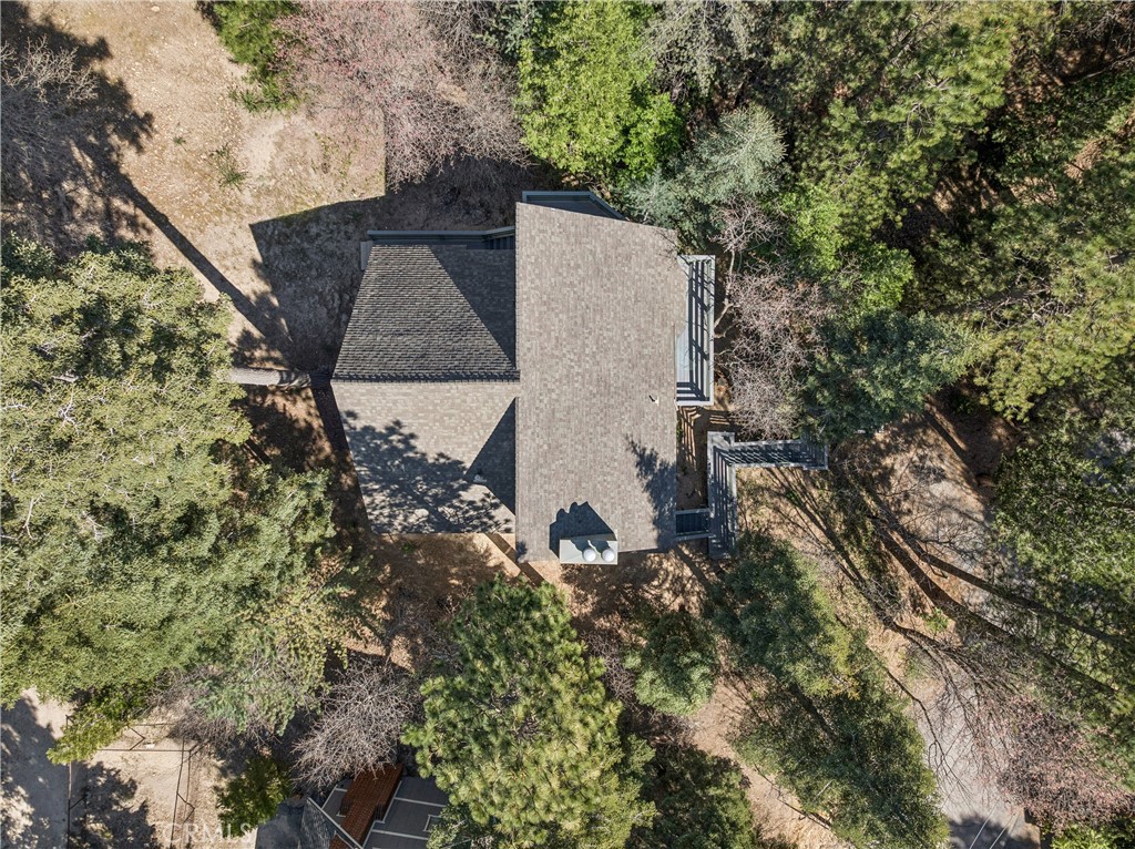 175 Massive Blue Jay, CA 92317 - Photo 38 of 40 an aerial view of a house with a yard and large trees