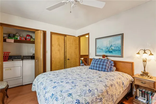 a bedroom with a large bed and a chandelier