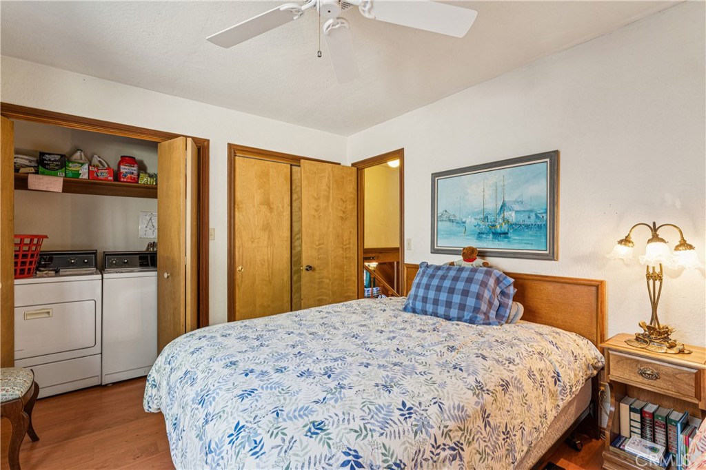 175 Massive Blue Jay, CA 92317 - Photo 10 of 40 a bedroom with a large bed and a chandelier