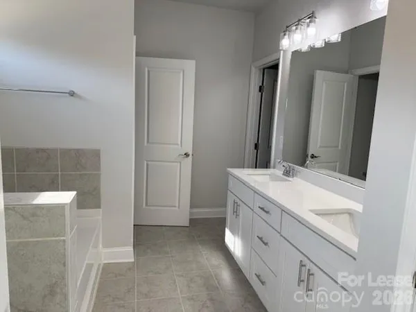 a bathroom with a double vanity sink and a mirror