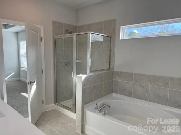 a bathroom with a bathtub and shower