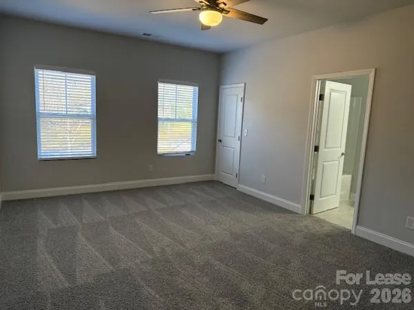 an empty room with windows and closet