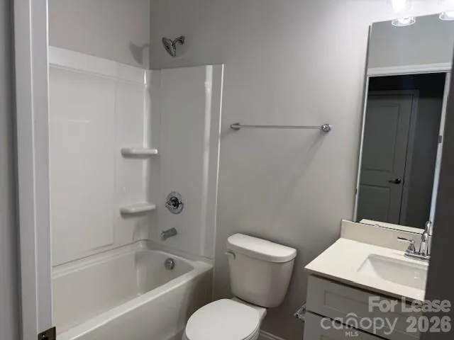 a white toilet sitting next to a bath tub