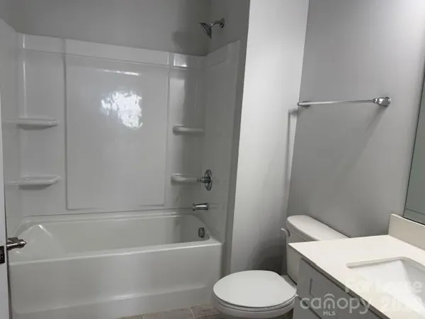 a bathroom with a toilet a sink and bathtub