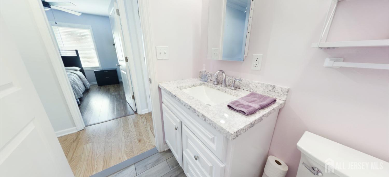 67 Columbus Avenue Edison, NJ 08817 - Photo 11 of 23 a bathroom with a sink a toilet and vanity