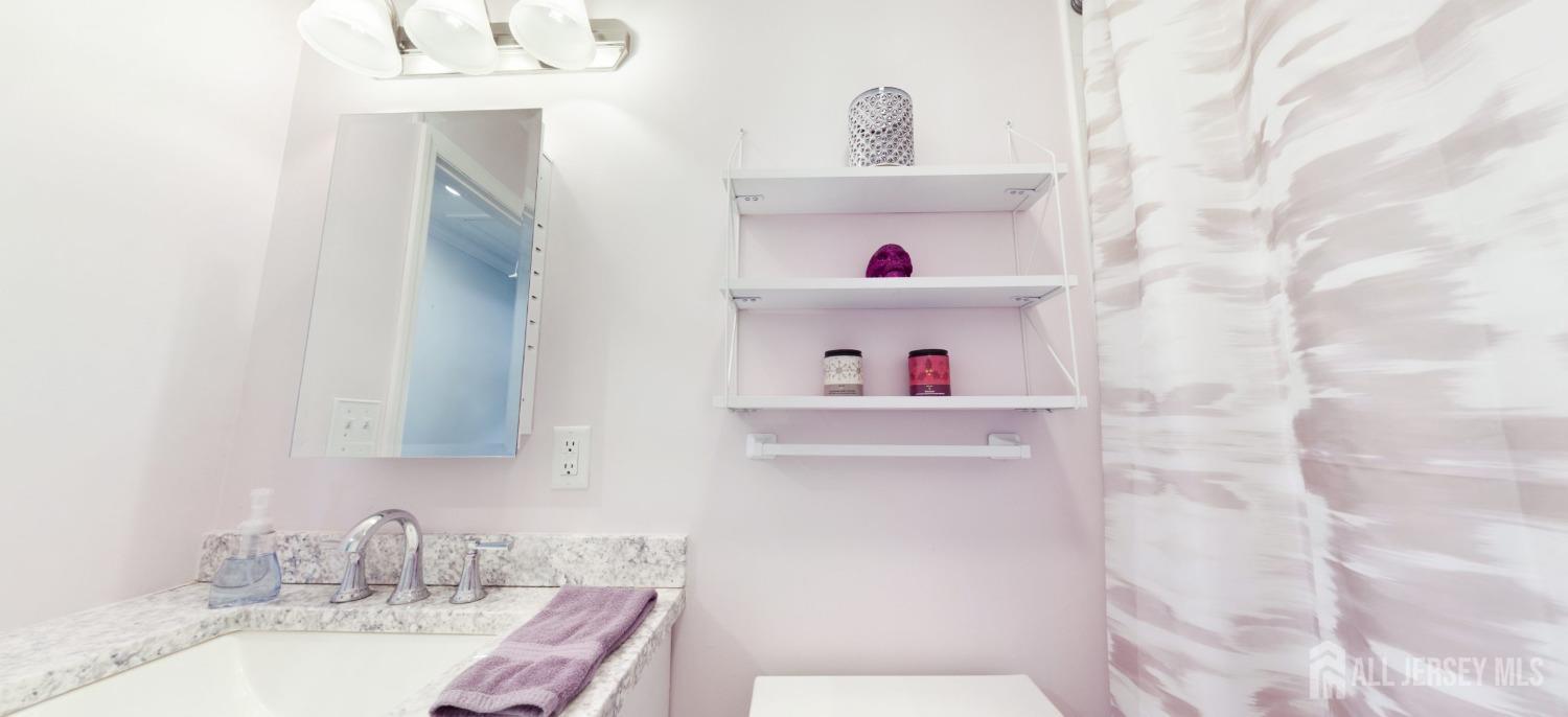 67 Columbus Avenue Edison, NJ 08817 - Photo 12 of 23 a bathroom with a sink and a mirror