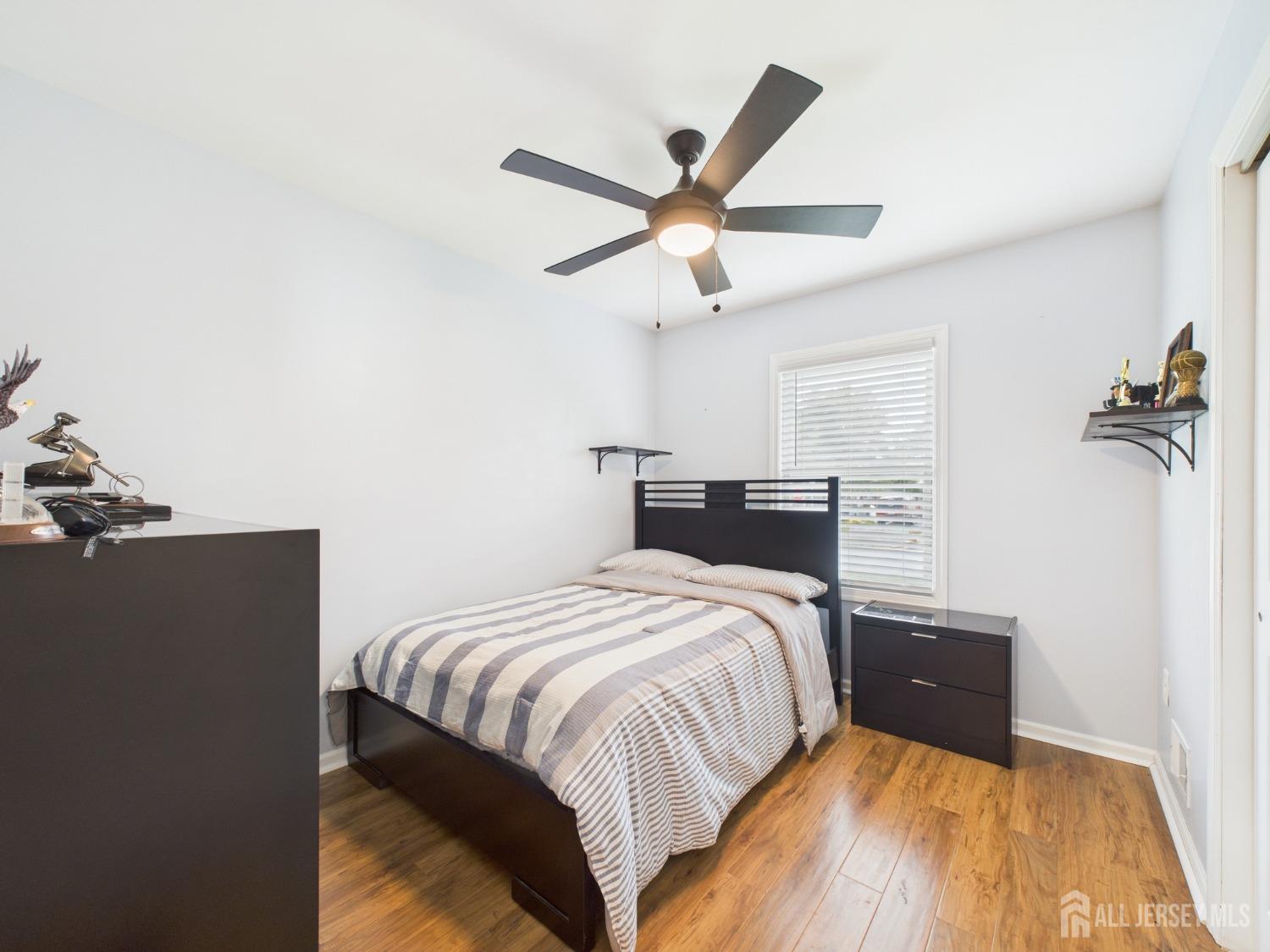 67 Columbus Avenue Edison, NJ 08817 - Photo 13 of 23 a bedroom with a bed and a ceiling fan