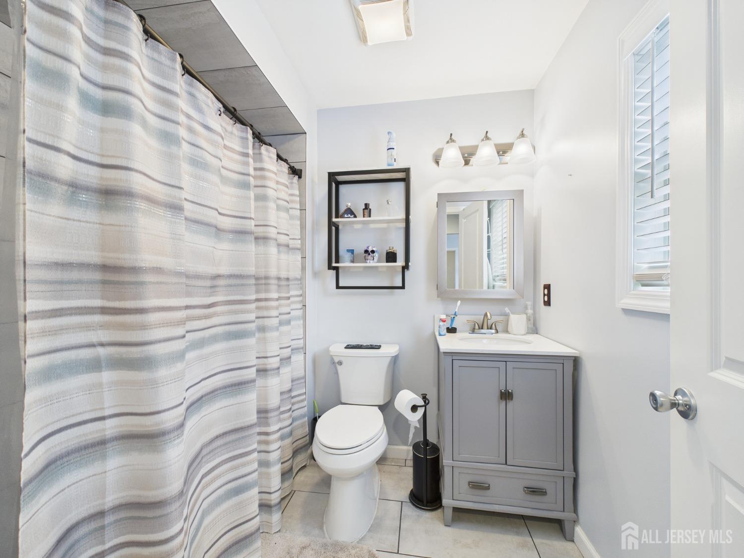 67 Columbus Avenue Edison, NJ 08817 - Photo 19 of 23 a bathroom with a toilet sink and mirror