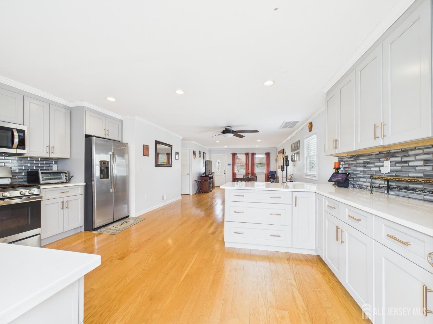 67 Columbus Avenue Edison, NJ 08817 - Photo 6 of 23 a large kitchen with cabinets and wooden floor