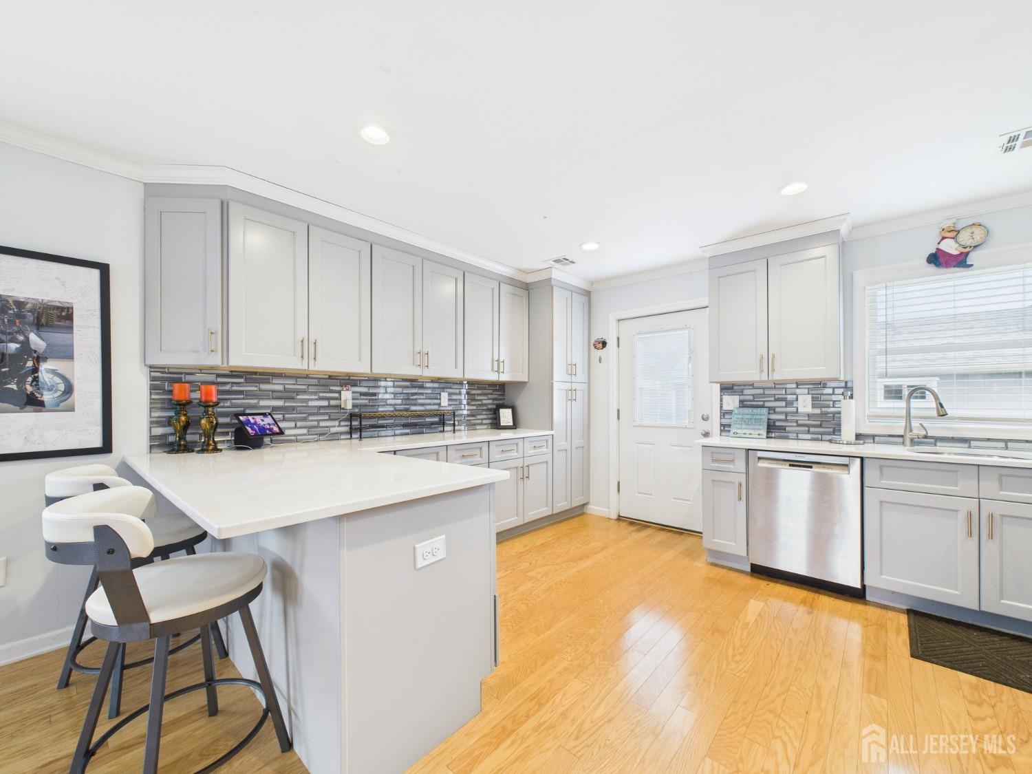 67 Columbus Avenue Edison, NJ 08817 - Photo 9 of 23 a kitchen with granite countertop a sink cabinets stainless steel appliances and a center island
