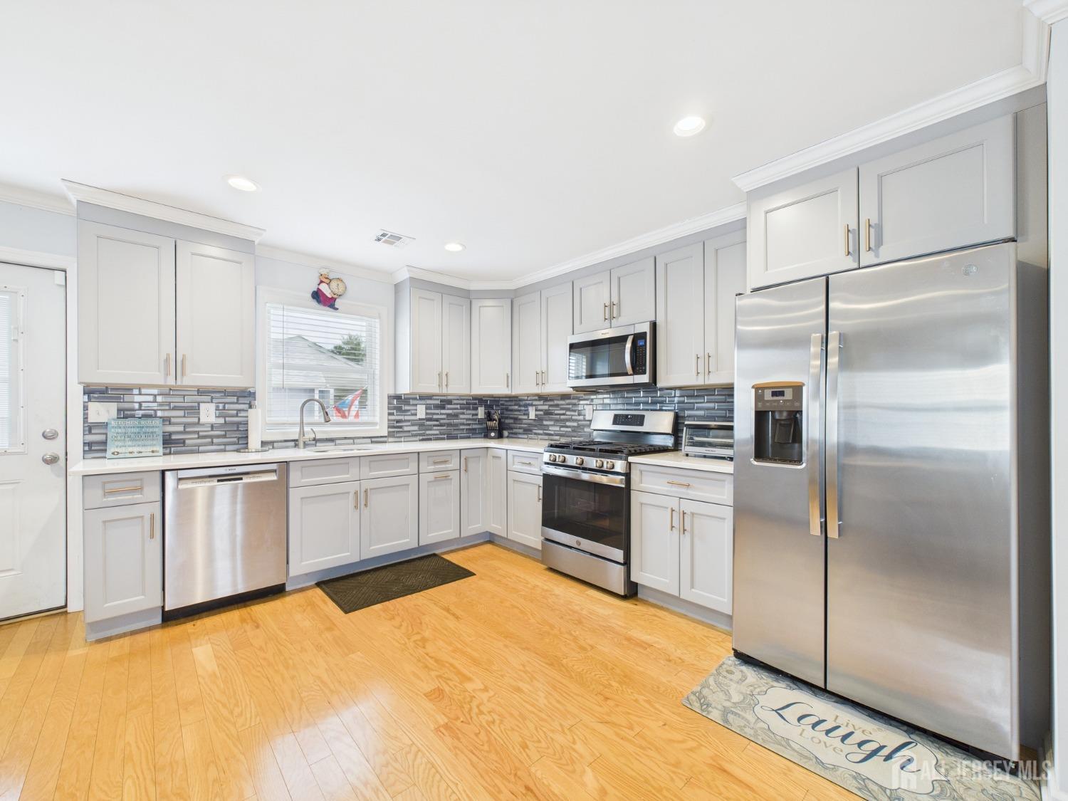 67 Columbus Avenue Edison, NJ 08817 - Photo 10 of 23 a kitchen with granite countertop stainless steel appliances and white cabinets