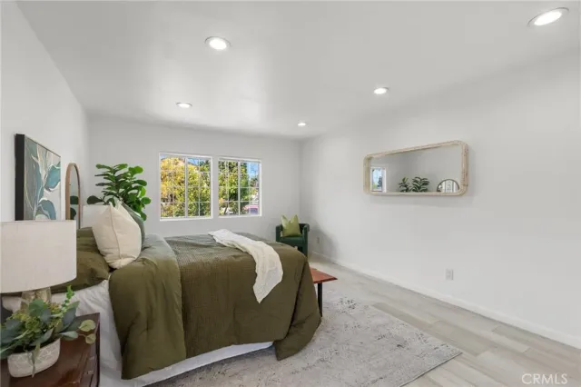 a kitchen with stainless steel appliances kitchen island granite countertop a refrigerator and a sink