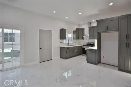 a kitchen with refrigerator and cabinets