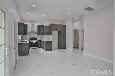 a kitchen with a refrigerator and a sink