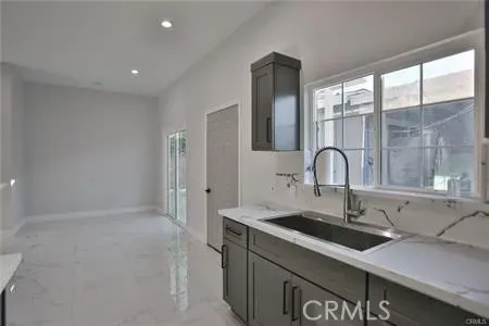 a spacious bathroom with a granite countertop sink a toilet and shower