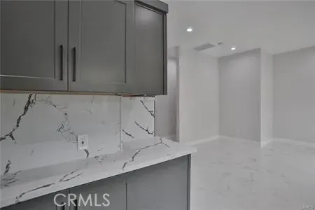 a bathroom with a granite countertop sink a toilet and shower