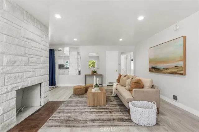 a living room with furniture and a fireplace