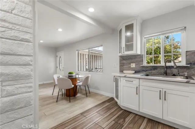 a kitchen with cabinets a sink and wooden floor