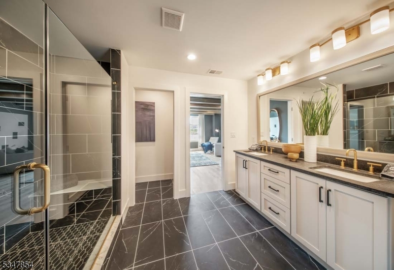 2 Blackmoor Lane Randolph, NJ 07869 - Photo 20 of 25 a large bathroom with a double vanity sink a mirror and a shower