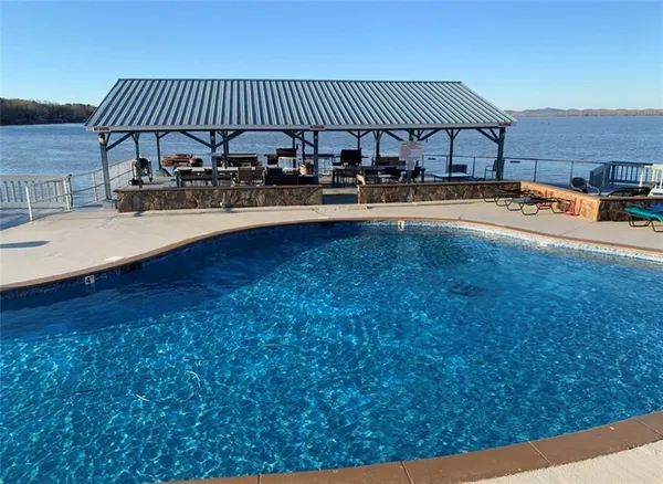 a swimming pool view with a outdoor seating
