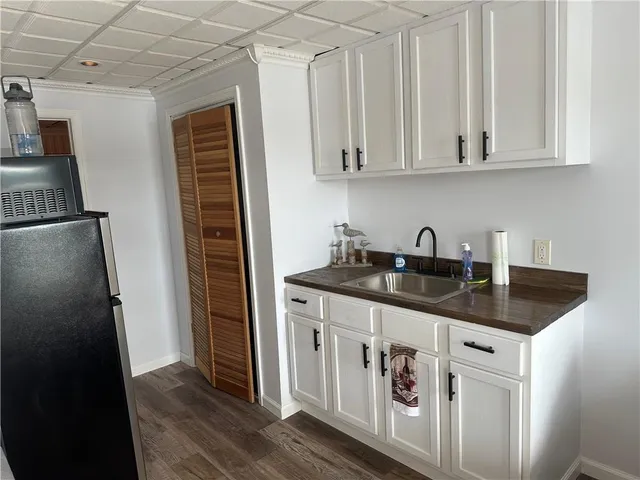 a kitchen with stainless steel appliances granite countertop a sink and a refrigerator