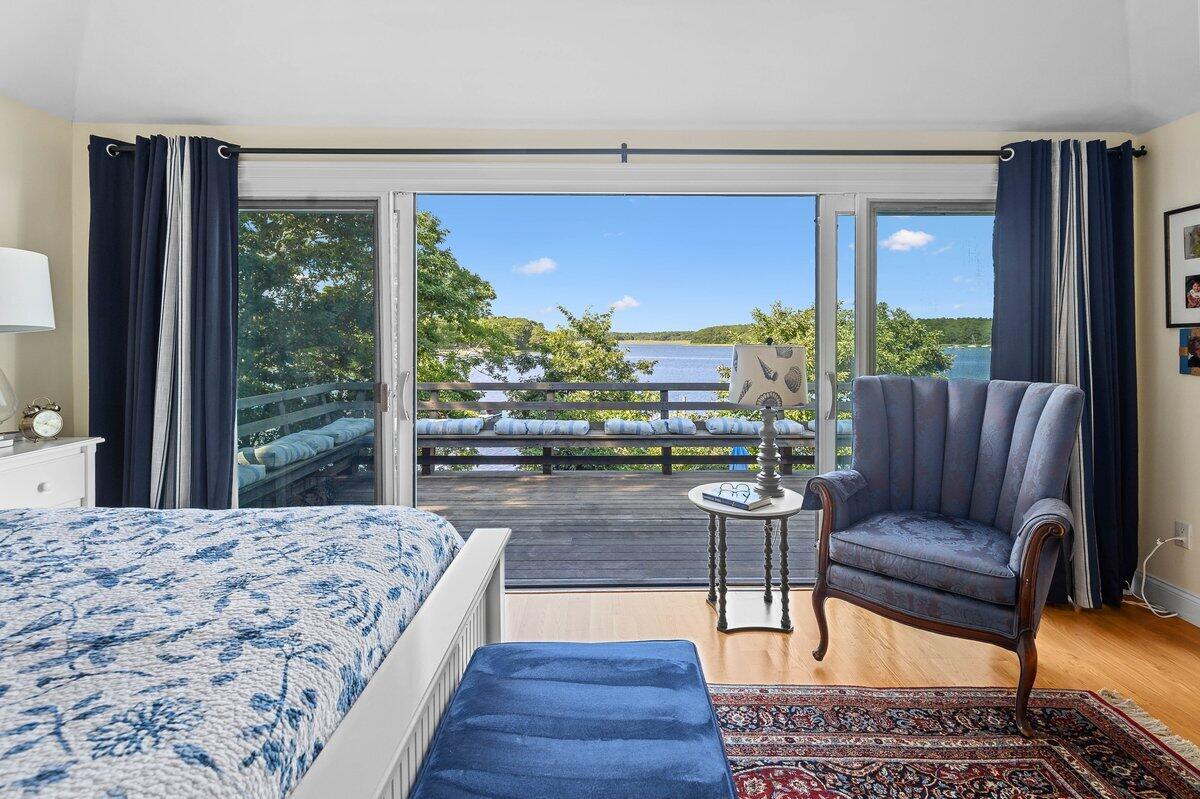 77 Tide Run Mashpee, MA 02649 - Photo 12 of 44 a living room with large windows and a table