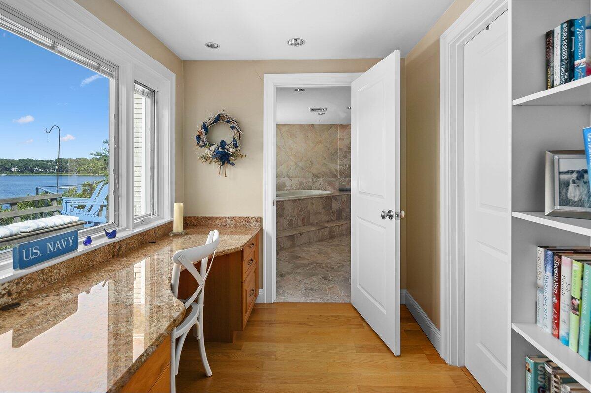 77 Tide Run Mashpee, MA 02649 - Photo 13 of 44 a room with a door open to a window with kitchen view