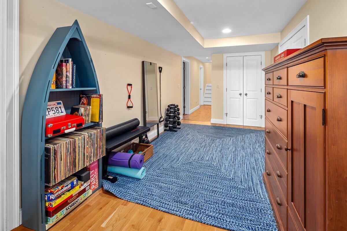 77 Tide Run Mashpee, MA 02649 - Photo 25 of 44 a living room with furniture a fireplace and gym equipment