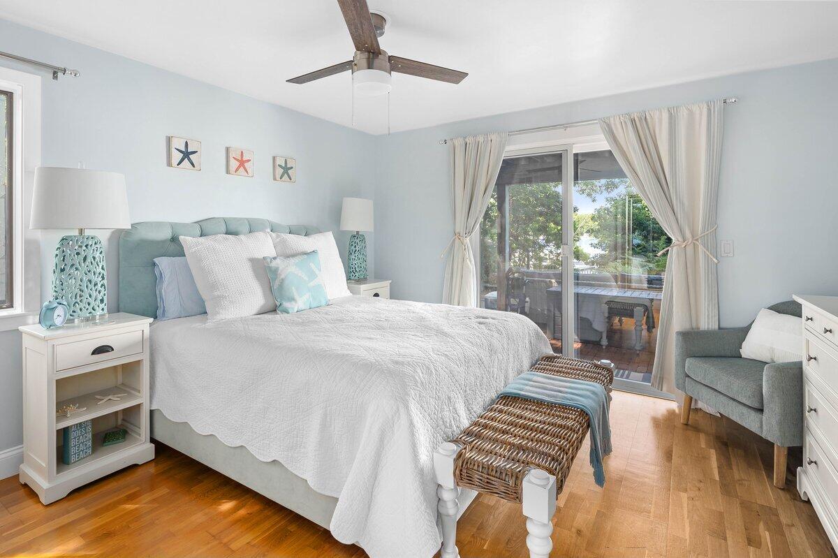 77 Tide Run Mashpee, MA 02649 - Photo 26 of 44 a bedroom with a bed and a chandelier