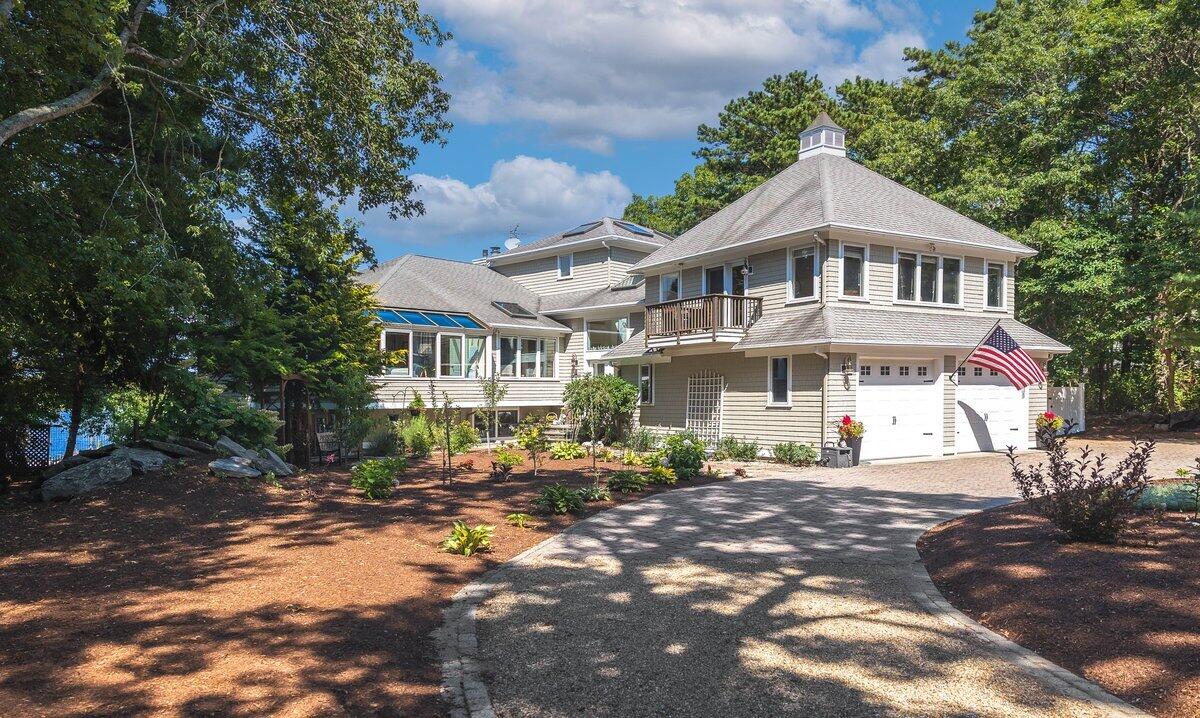 77 Tide Run Mashpee, MA 02649 - Photo 3 of 44 a front view of a house with a garden