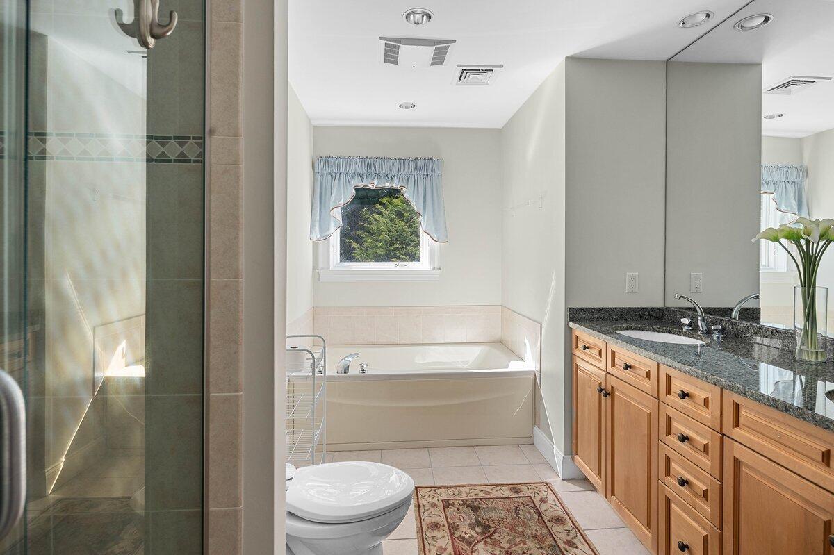 77 Tide Run Mashpee, MA 02649 - Photo 31 of 44 a bathroom with a granite countertop sink toilet and shower