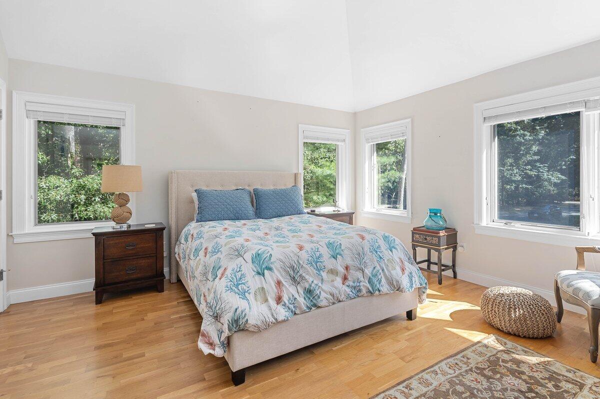 77 Tide Run Mashpee, MA 02649 - Photo 32 of 44 a bedroom with a bed and wooden floor