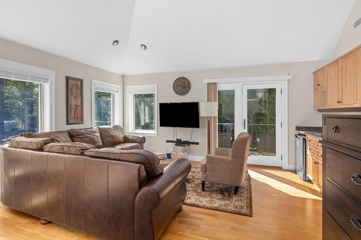 77 Tide Run Mashpee, MA 02649 - Photo 33 of 44 a living room with furniture fireplace and flat screen tv