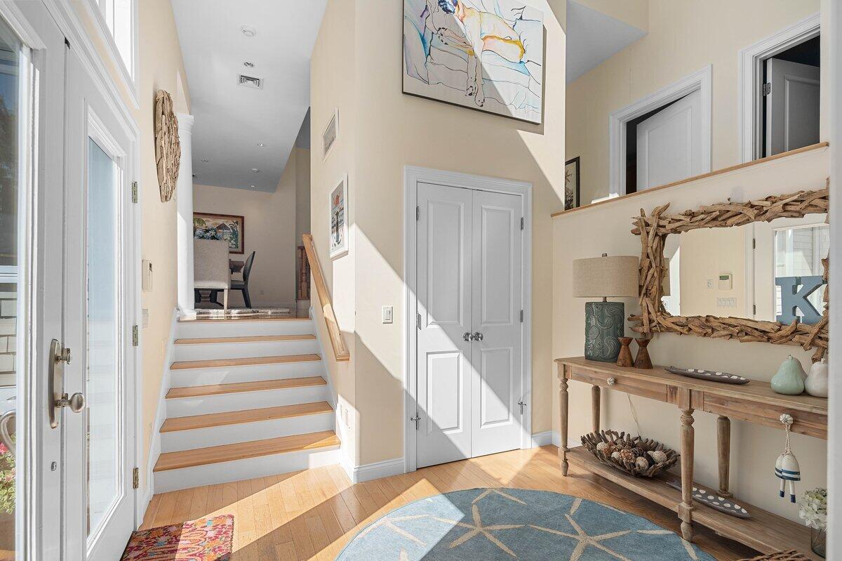 77 Tide Run Mashpee, MA 02649 - Photo 34 of 44 a view of a hallway to a livingroom with wooden floor and staircase