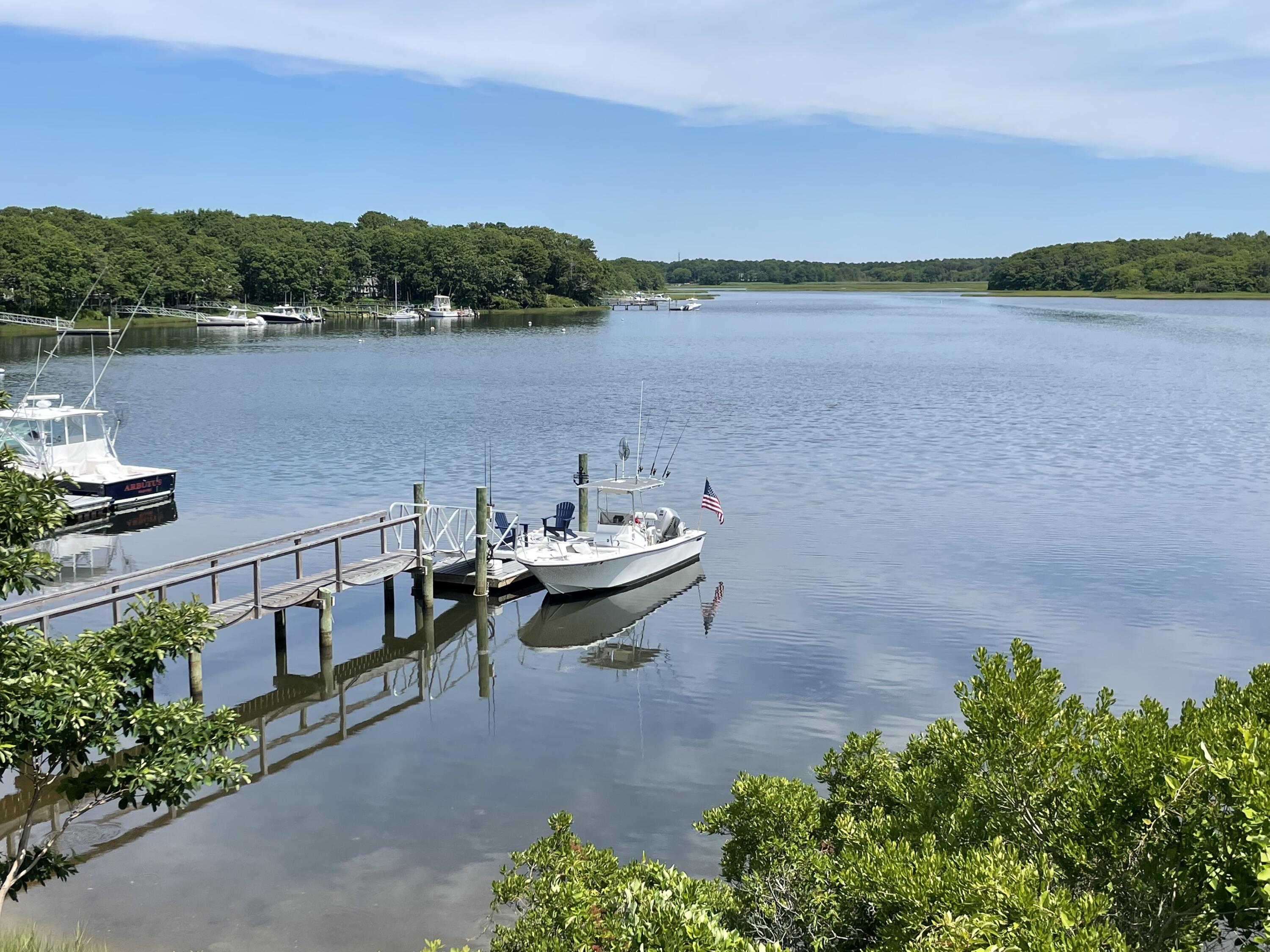 77 Tide Run Mashpee, MA 02649 - Photo 36 of 44 a view of a lake with a mountain in the background