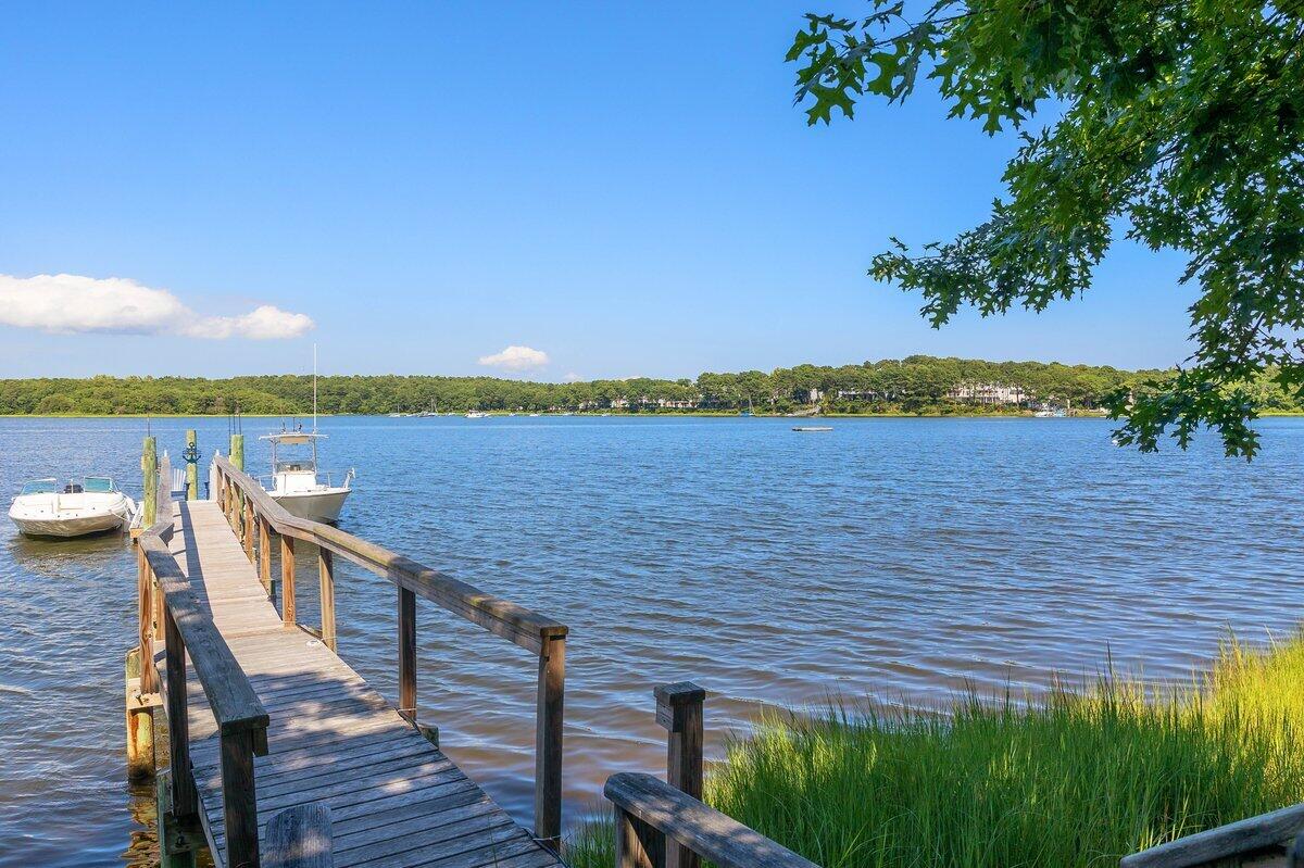 77 Tide Run Mashpee, MA 02649 - Photo 37 of 44 a view of a terrace with wooden floor and lake view