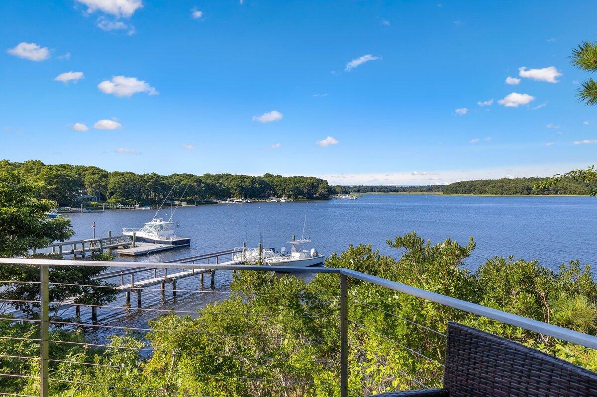 77 Tide Run Mashpee, MA 02649 - Photo 41 of 44 a view of a lake with couches in the patio