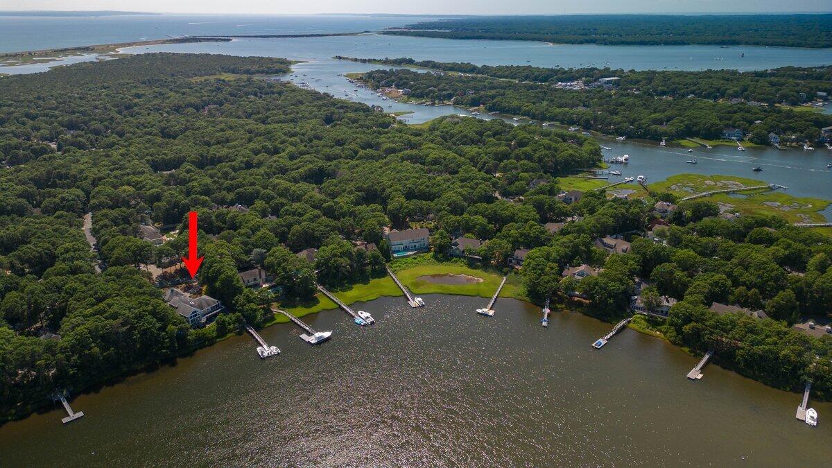 77 Tide Run Mashpee, MA 02649 - Photo 5 of 44 an aerial view of a houses with a yard and lake view