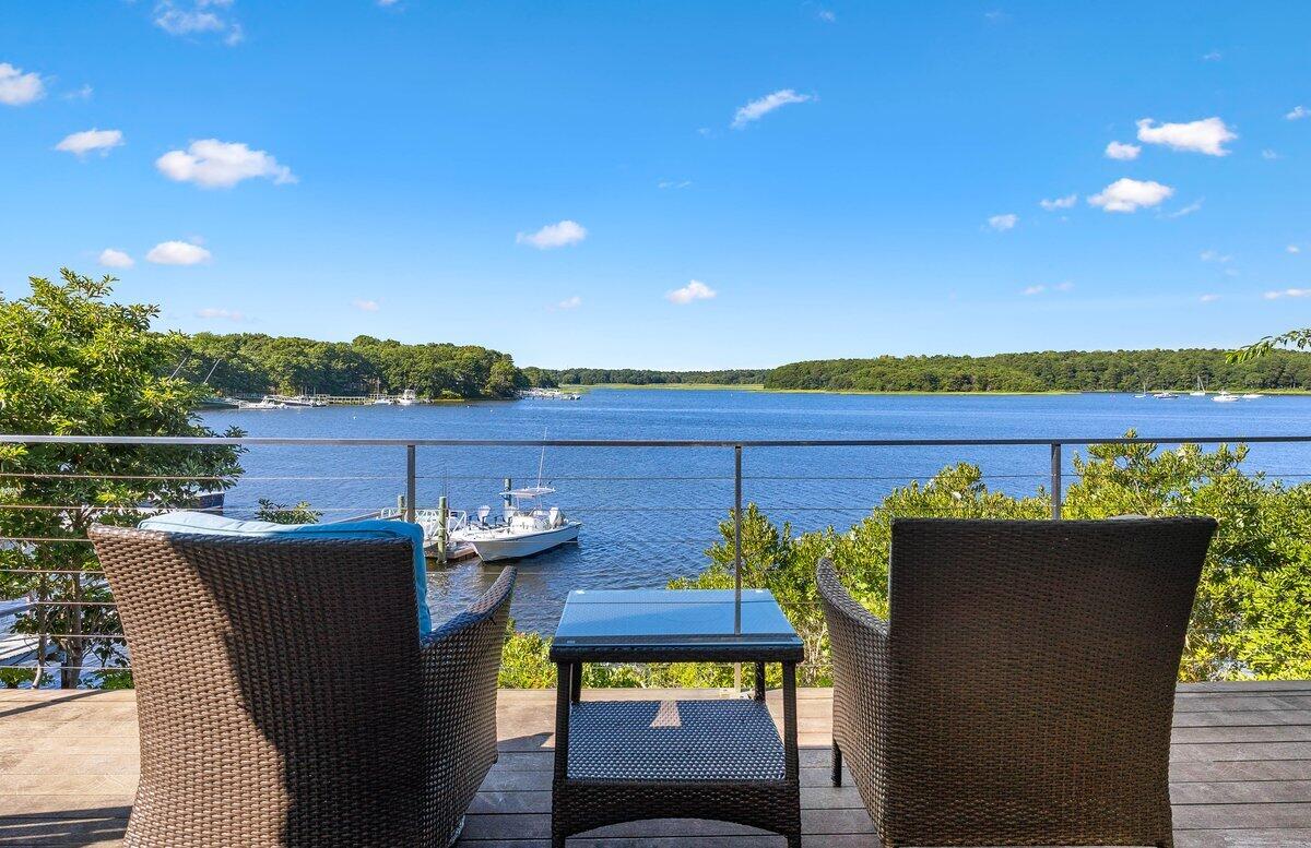 77 Tide Run Mashpee, MA 02649 - Photo 7 of 44 a view of a chairs and table in the terrace
