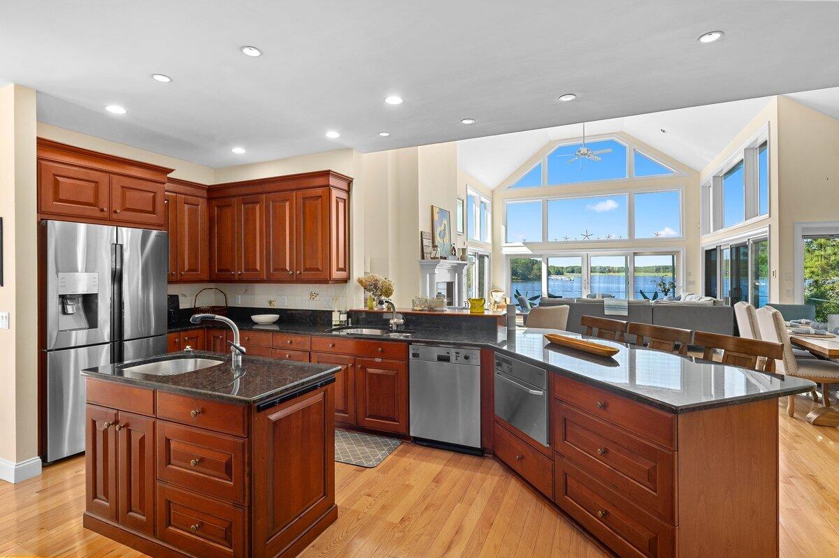 77 Tide Run Mashpee, MA 02649 - Photo 8 of 44 a kitchen with stainless steel appliances granite countertop a sink stove and refrigerator