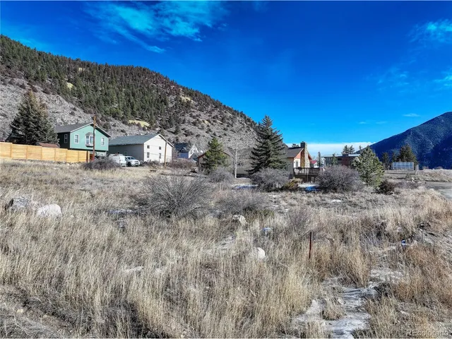 a view of dirt road with a building in the background