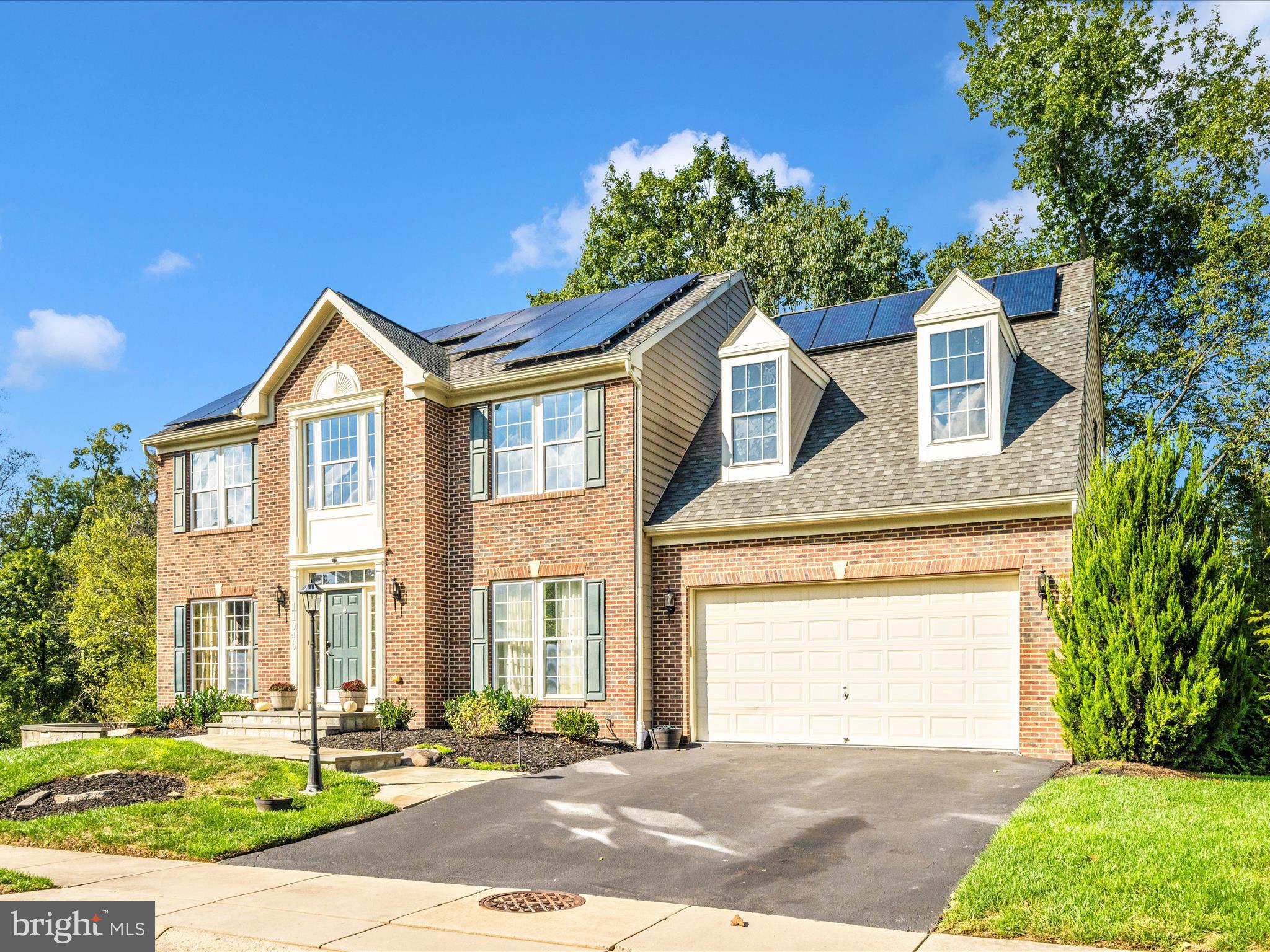 11046 Country Club Road New Market, MD 21774 - Photo 61 of 105 a front view of a house with a yard and garage
