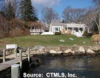 a front view of a house with a yard table and chairs