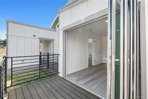 a view of a porch with wooden floor and a hallway