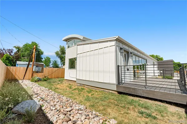 a view of a house with a wooden fence
