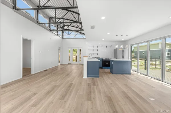 a view of a room with wooden floor and windows