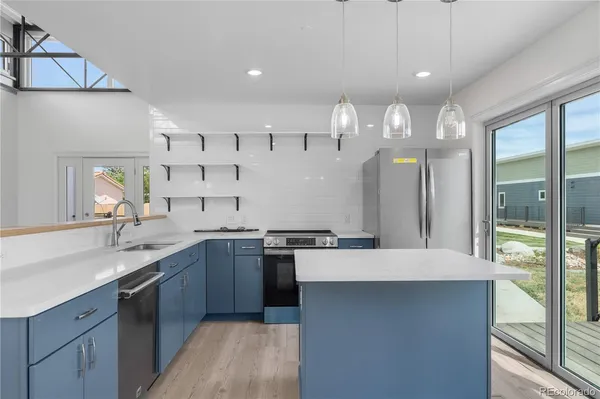 a large kitchen with a large counter top appliances and cabinets