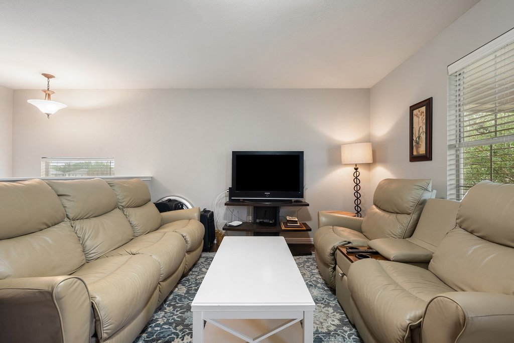 140 Wolfberry Path Buda, TX 78610 - Photo 20 of 35 a living room with furniture and a flat screen tv