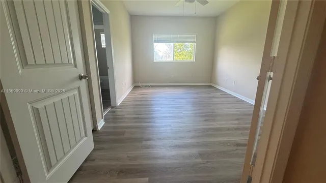 a view of a hallway with wooden floor