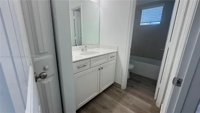 a bathroom with a toilet and a bathtub